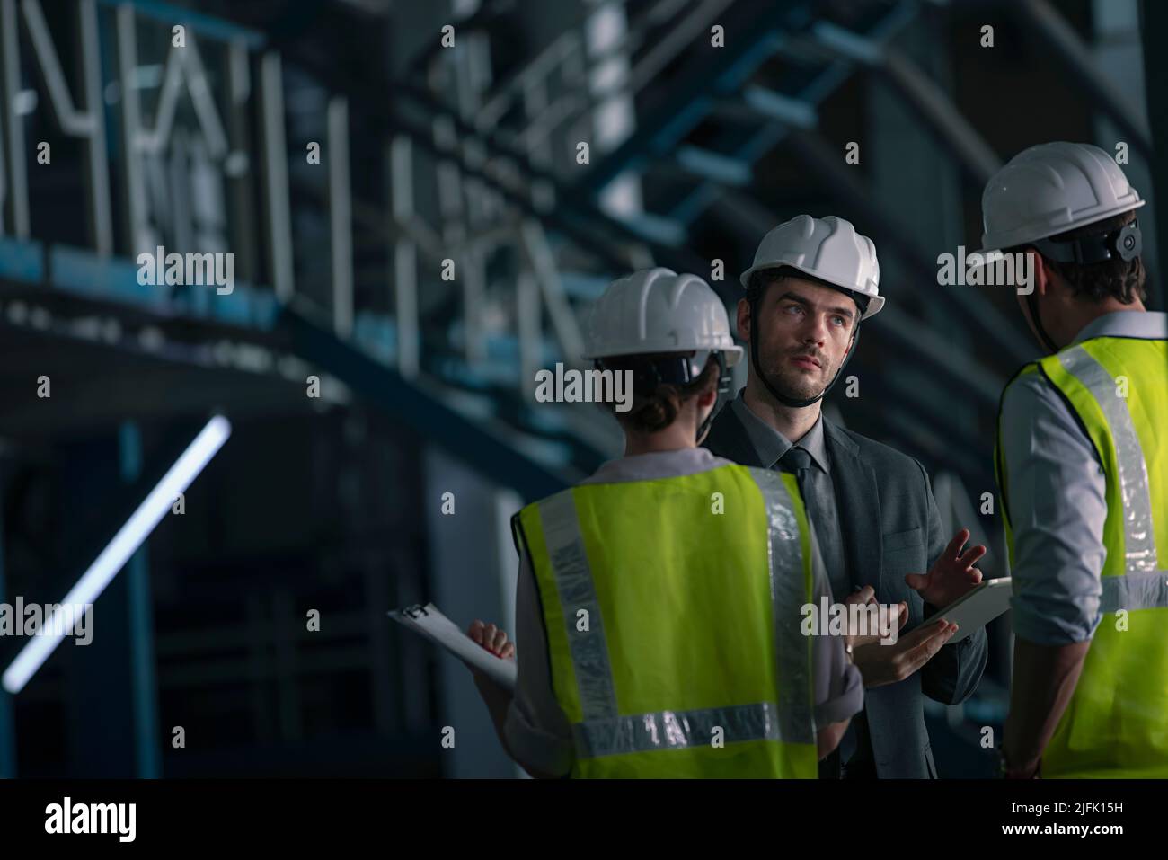 Businessman in meeting with his employee in the factory Stock Photo