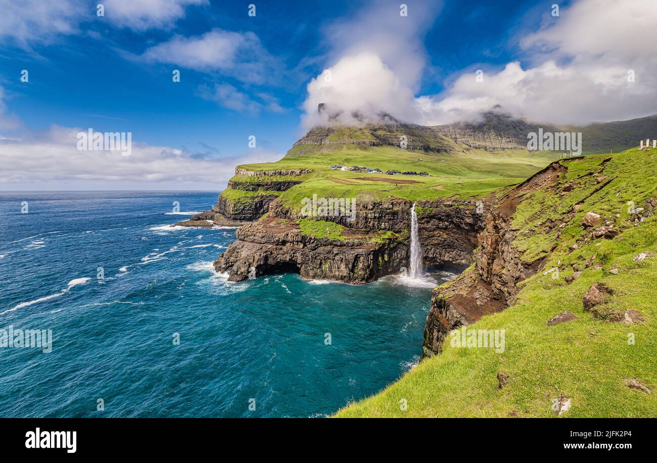 Gasadalur with Mulafossur waterfall on Vagar, Faroe Islands Stock Photo