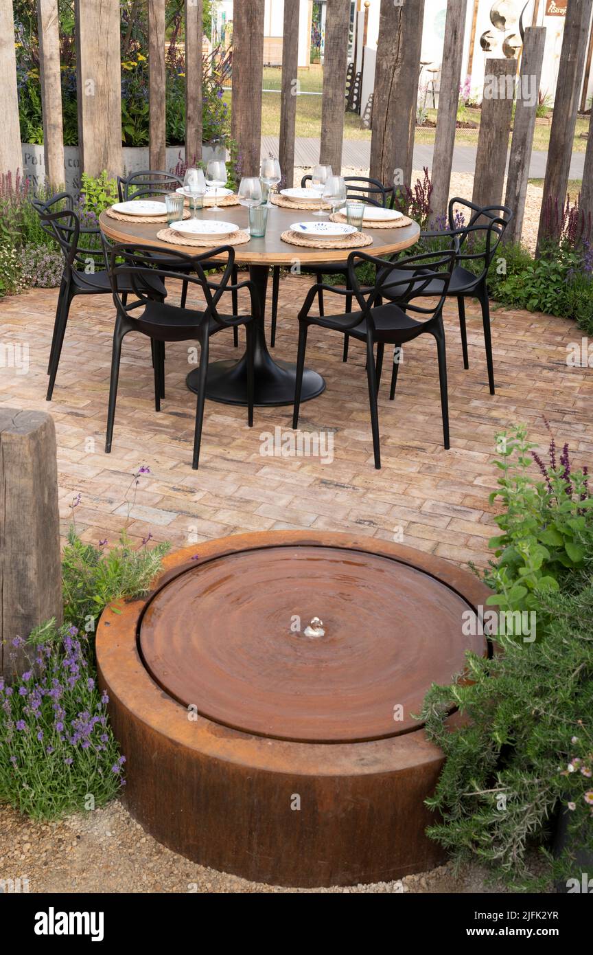 Hampton Court Palace, Surrey, UK. 4 July 2022. RHS Hampton Court Palace Garden Festival press day for the worlds largest flower show, running till 9 July 2022. Image: Feature garden: The Vitamin G Garden designed by Alan Williams with Jo Whiley is inspired by the evidence-based research that was published in April 2021 by RHS  scientists Professor Alistair Griffiths and Dr Lauriane Chalmin-Pui that proves how gardening benefits our mental, physical and social wellbeing. Credit: Malcolm Park/Alamy Live News Stock Photo