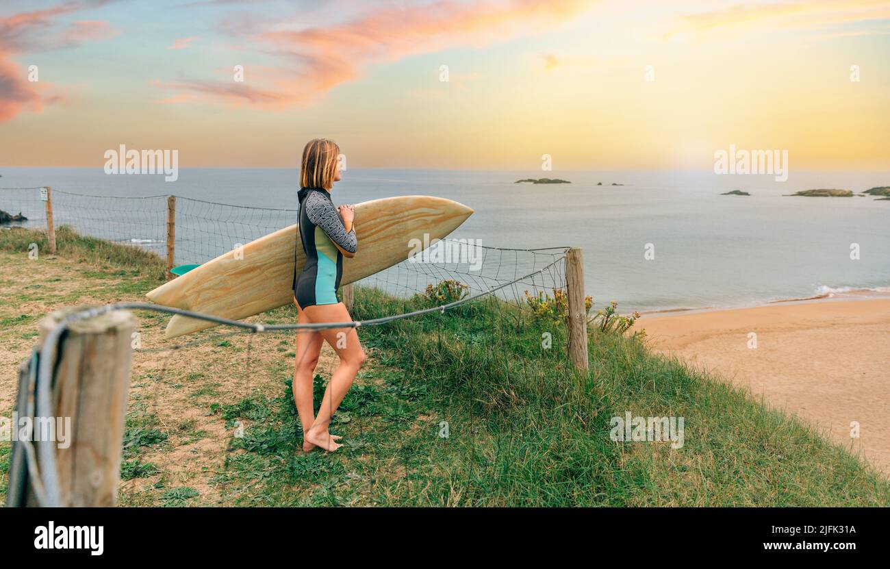 Woman holding surfing board hi-res stock photography and images - Alamy