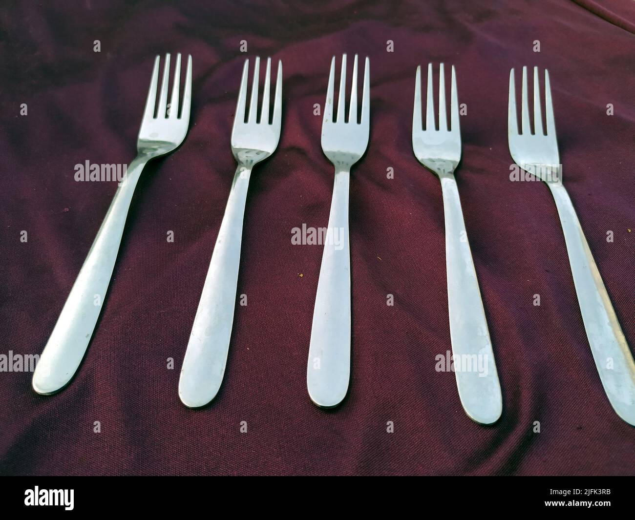 Empty  Steel Fork isolated on violet  background Stock Photo