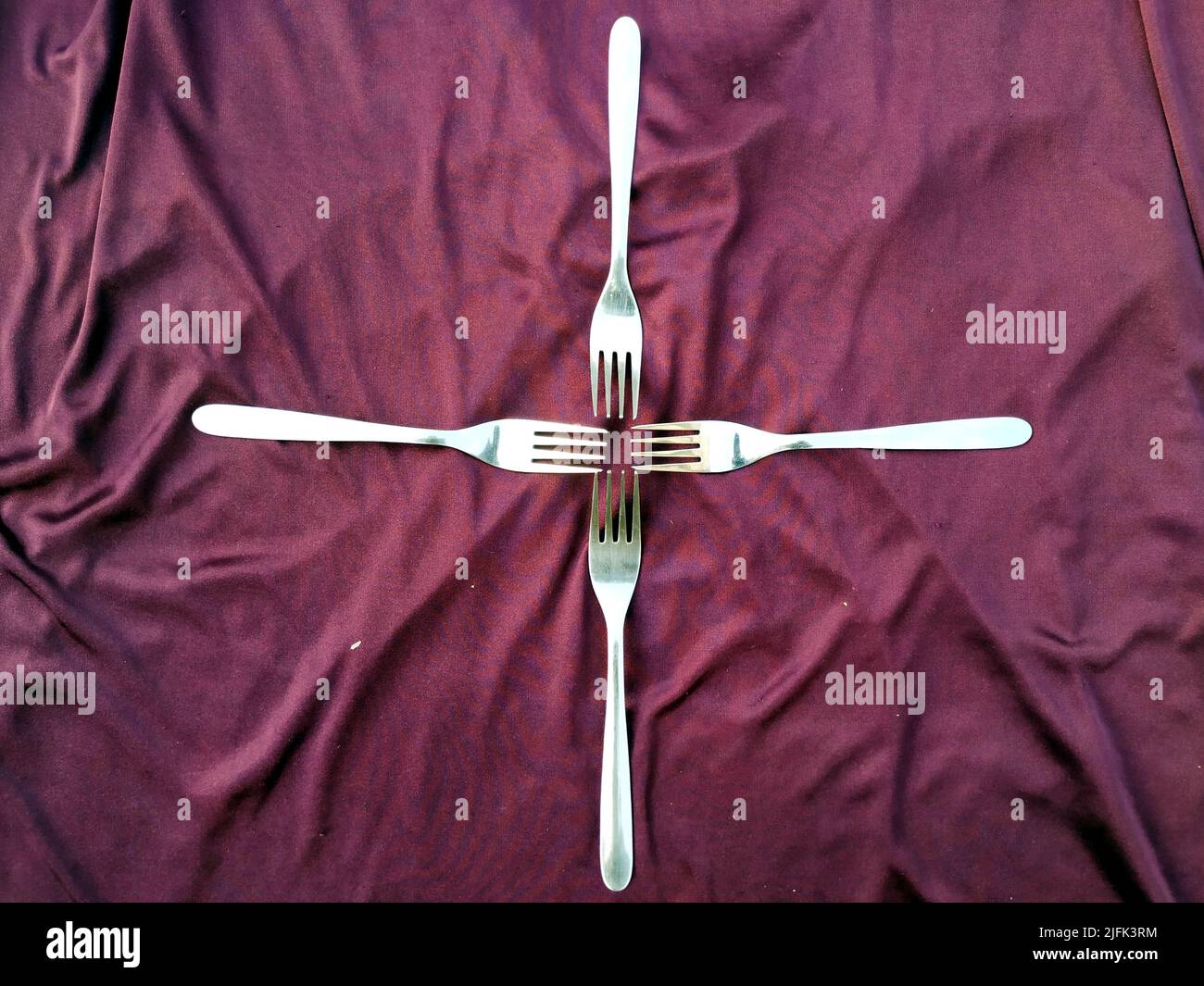 Empty  Steel Fork isolated on violet  background Stock Photo