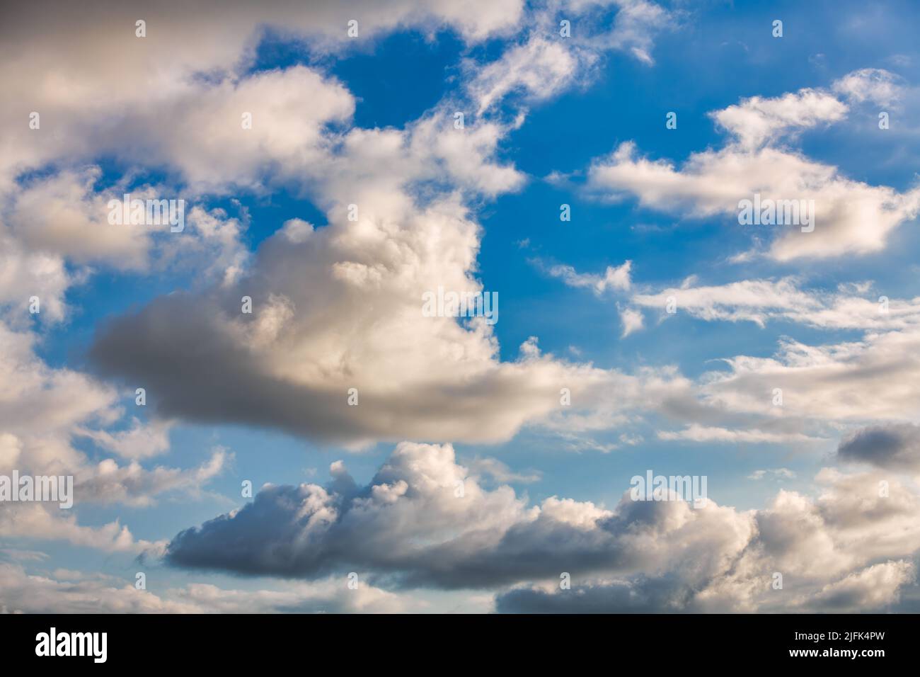 A Detailed Image Of White Fluffy Cumulus Clouds Set Against A Blue Daytime Sky Stock Photo
