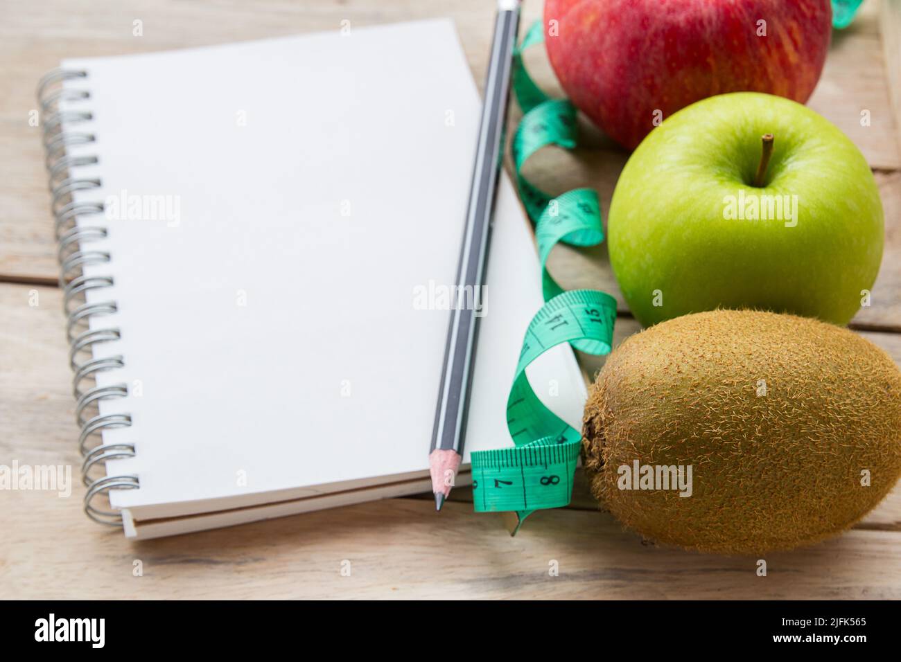 Healthy lifestyle concept with notepad, red apple. Weight loss or diet concept. Red apple and