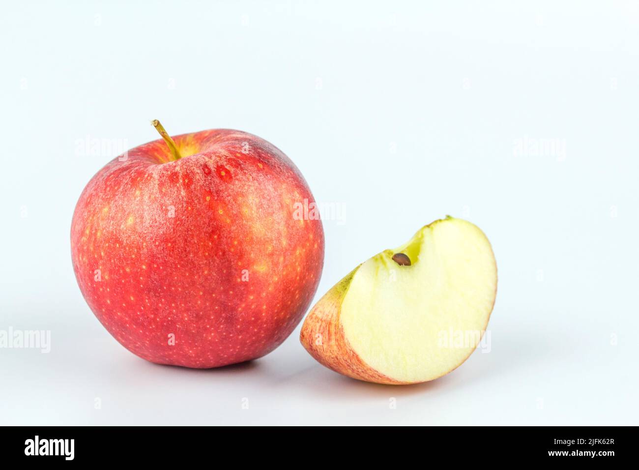 Sliced red apple isolated on white background. Stock Photo