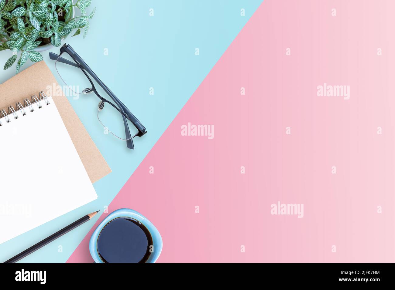 Minimal workspace with Laptop, glasses,flower,notepad and smartphone