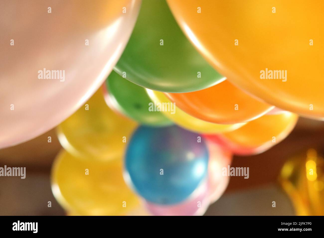 The view of colorful birthday balloons hanging from the ceiling Stock Photo