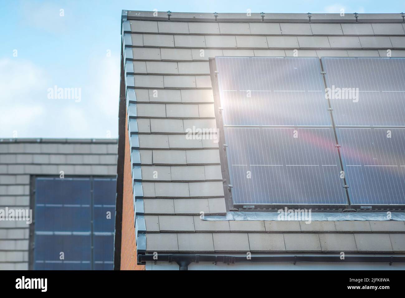Solar panels mounted on the roof of a modern new-build house in England ...