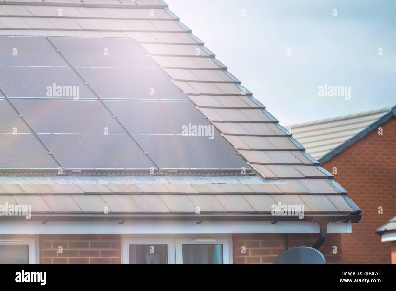 Solar panels mounted on the roof of a modern newbuild house in England