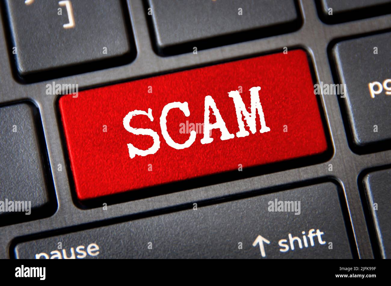 Scam text on red laptop tab. Online security concept Stock Photo