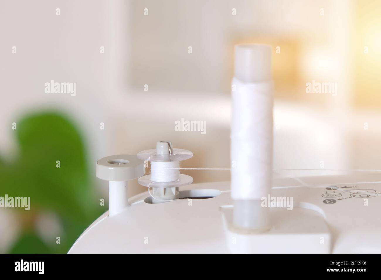 Winding threads on a bobbin on a sewing machine Stock Photo Alamy
