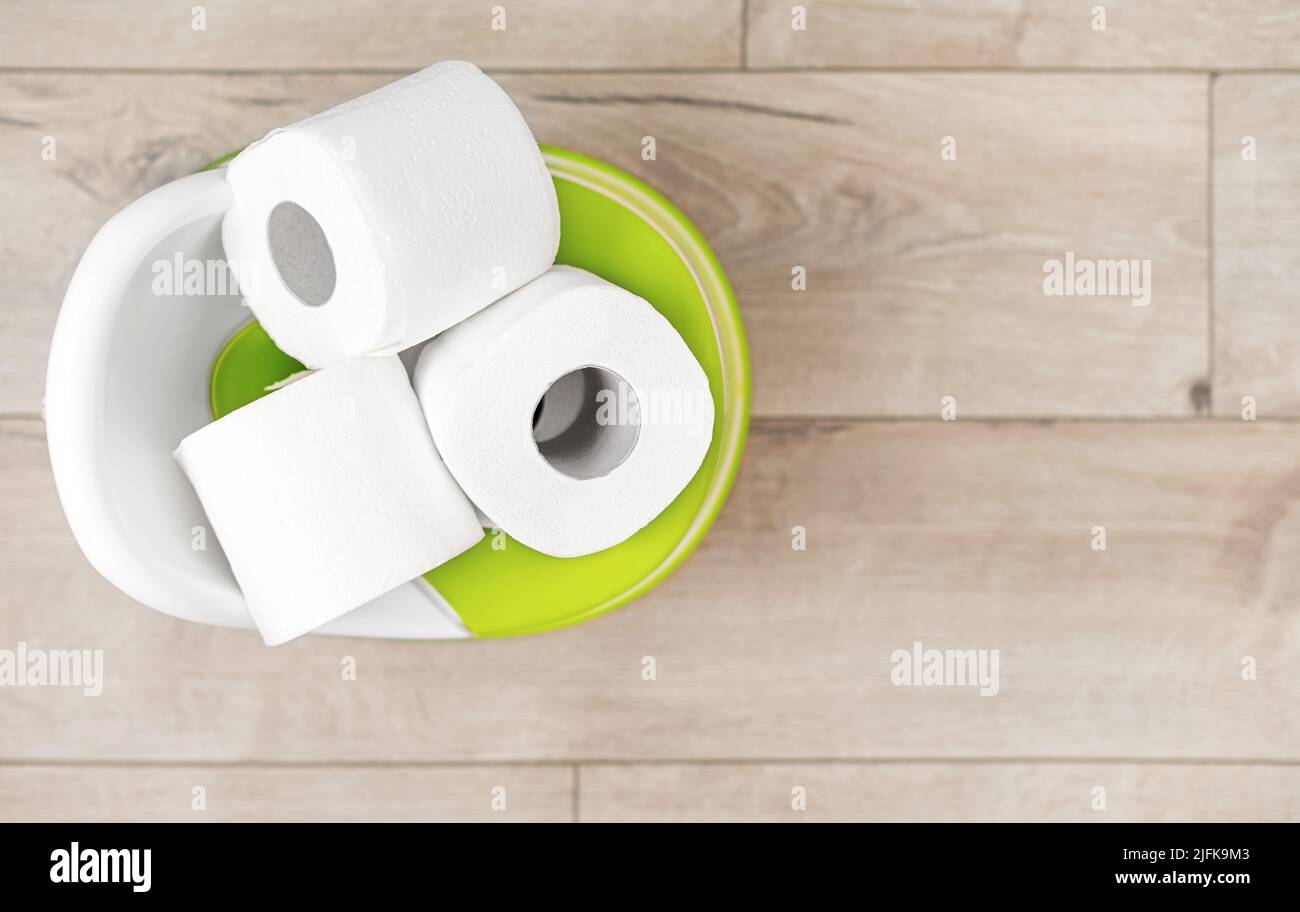 Toilet paper on a roll inside a baby potty Stock Photo Alamy