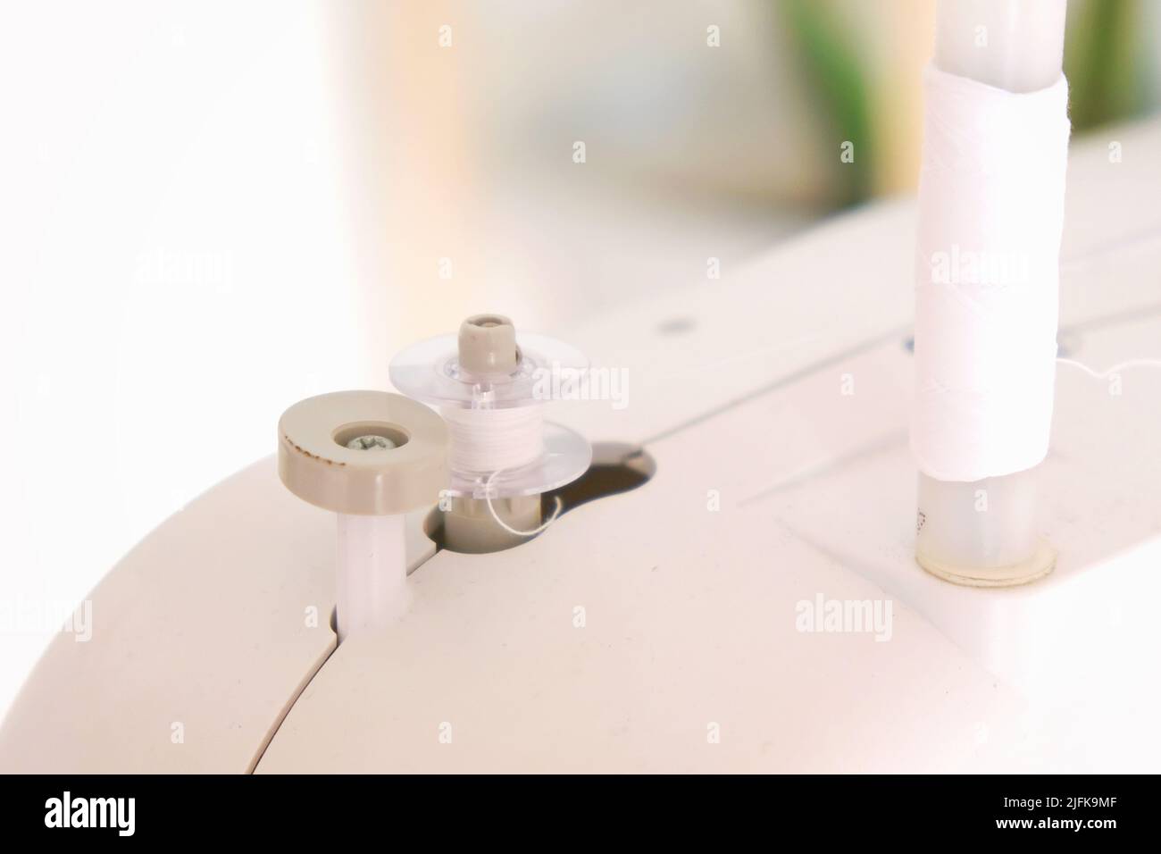 Winding threads on a bobbin on a sewing machine Stock Photo Alamy