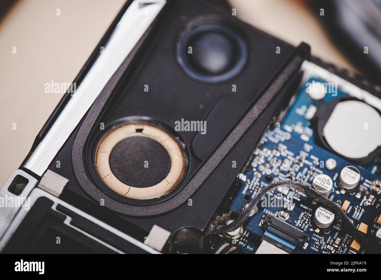 Closeup broken spaker inside the old computer. Computer service and repair concept. Stock Photo