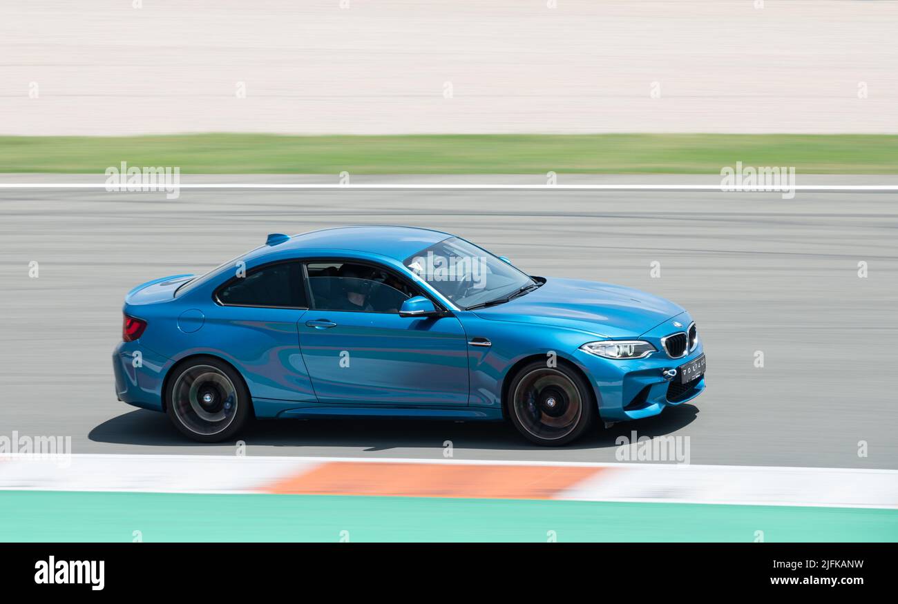 blue colored BMW M2 running on the Valencia racing circuit Stock Photo ...