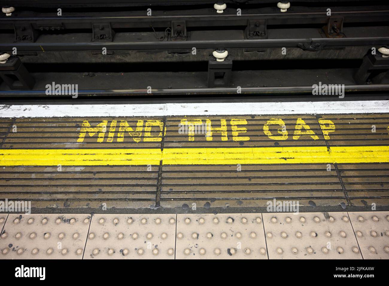 Mind the Gap warning on the edge of a London Underground station platform, London, United Kingdom. Stock Photo