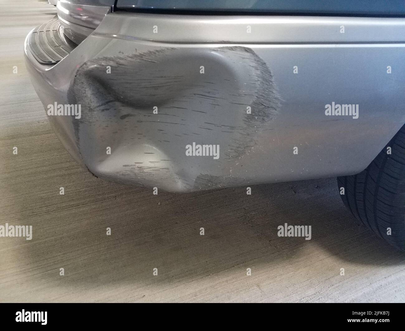 small dent in rear bumper on car Stock Photo Alamy
