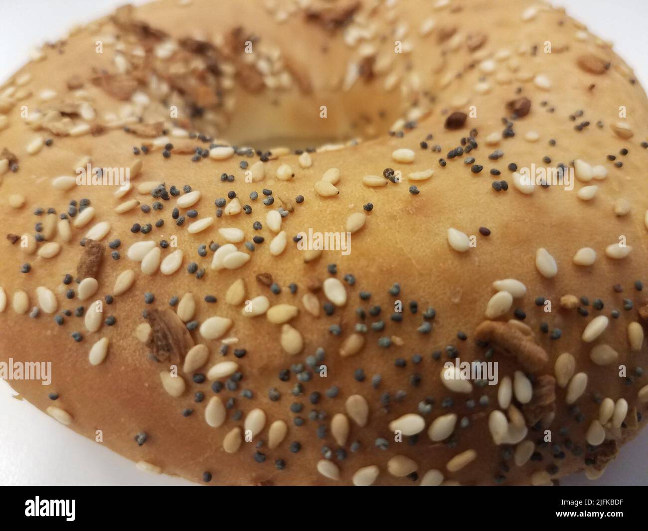 a bagel with onion and sesame seeds and poppy seeds Stock Photo Alamy