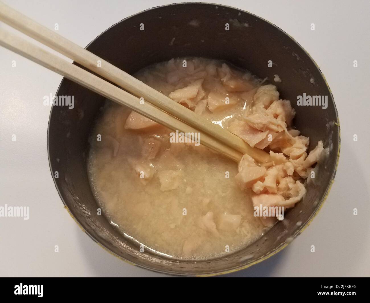 open can of canned white meat chicken in broth with chopsticks Stock