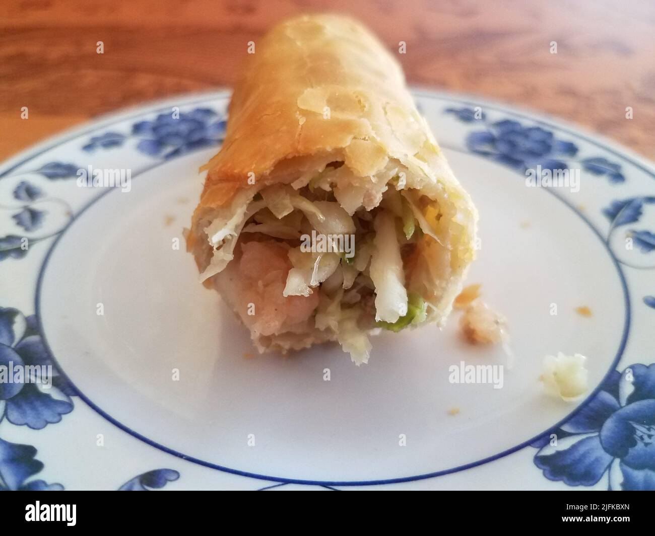 Chinese egg roll appetizer on white plate on table with shrimp and cabbage Stock Photo Alamy