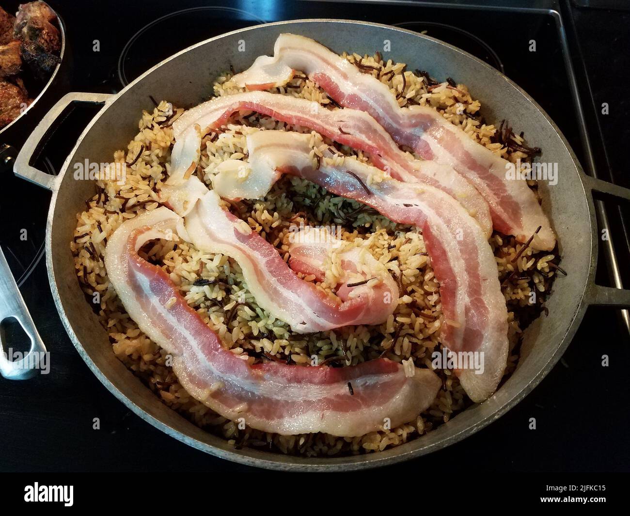 https://c8.alamy.com/comp/2JFKC15/puerto-rico-food-rice-with-bacon-in-metal-pot-on-stove-2JFKC15.jpg