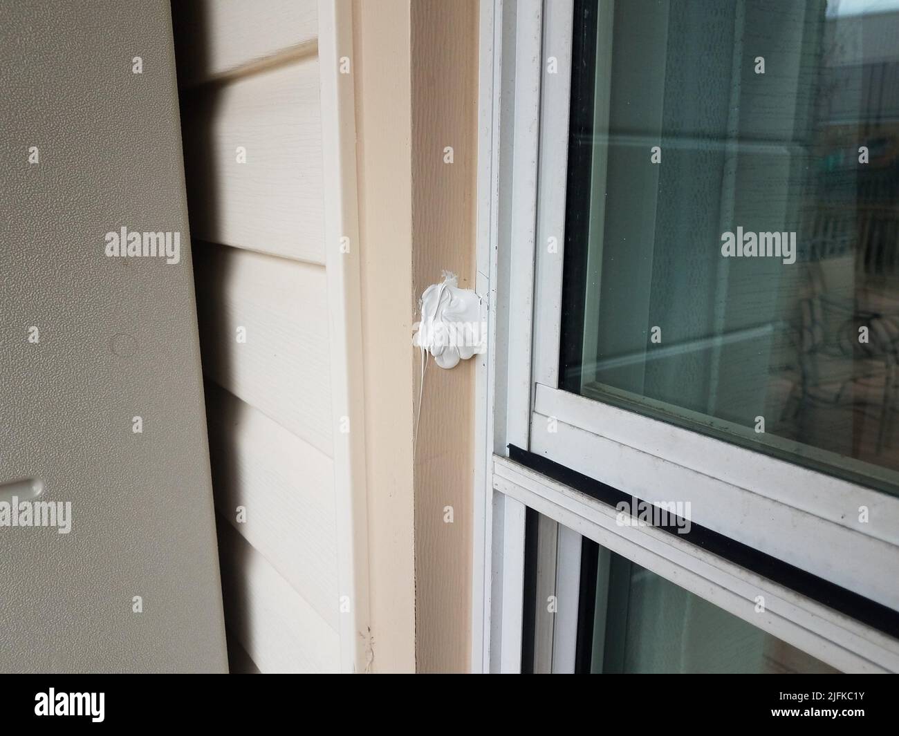 hole in broken or damaged metal frame of window on house or home with