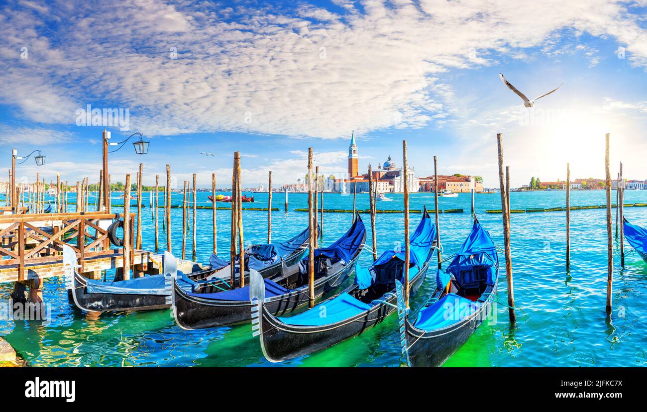 Traditional Gondolas moored on the Pier in the Grand Canal by San Giorgio Maggiore, Venice, Italy. Stock Photo