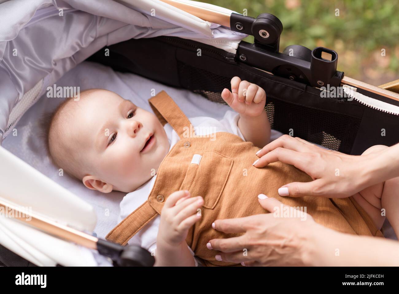 Baby Riding Roster Photo of sweet cute mom small daughter wear casual outfits walking ...