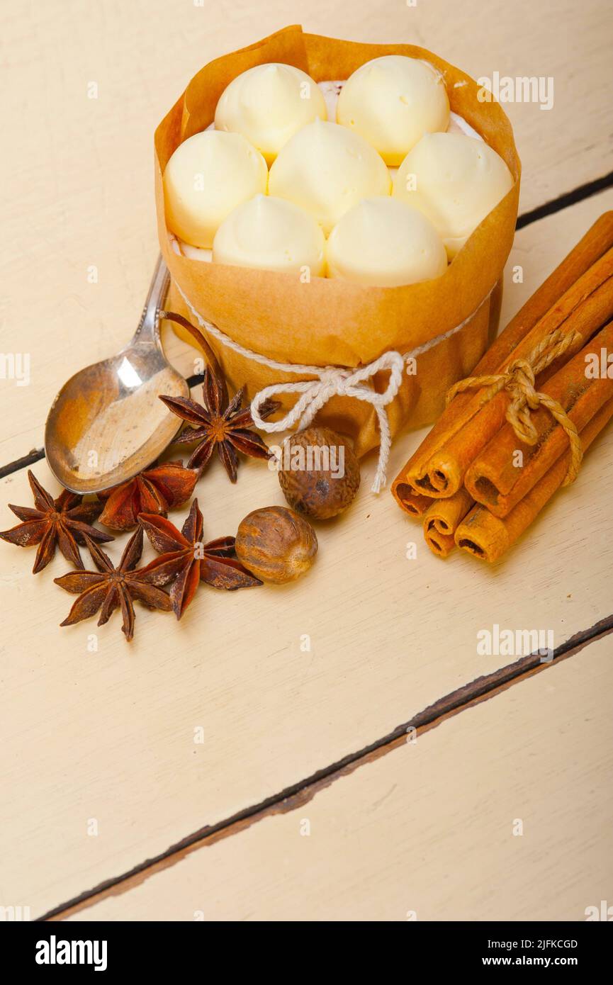fresh vanilla and spice cream cake dessert over a rustic white wood table. Stock Photo