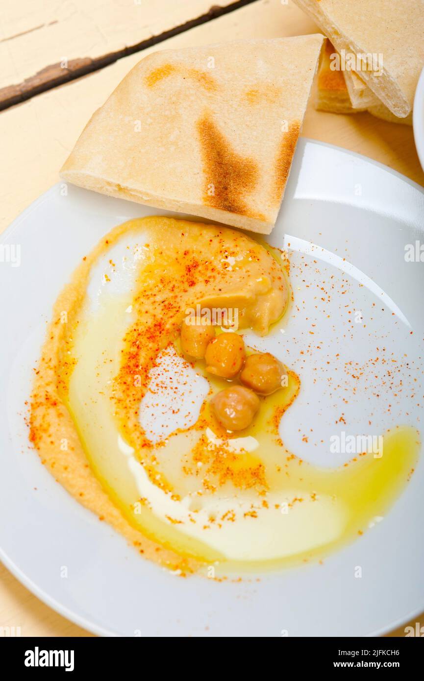 traditional chickpeas Hummus with pita bread and paprika on top. Stock Photo