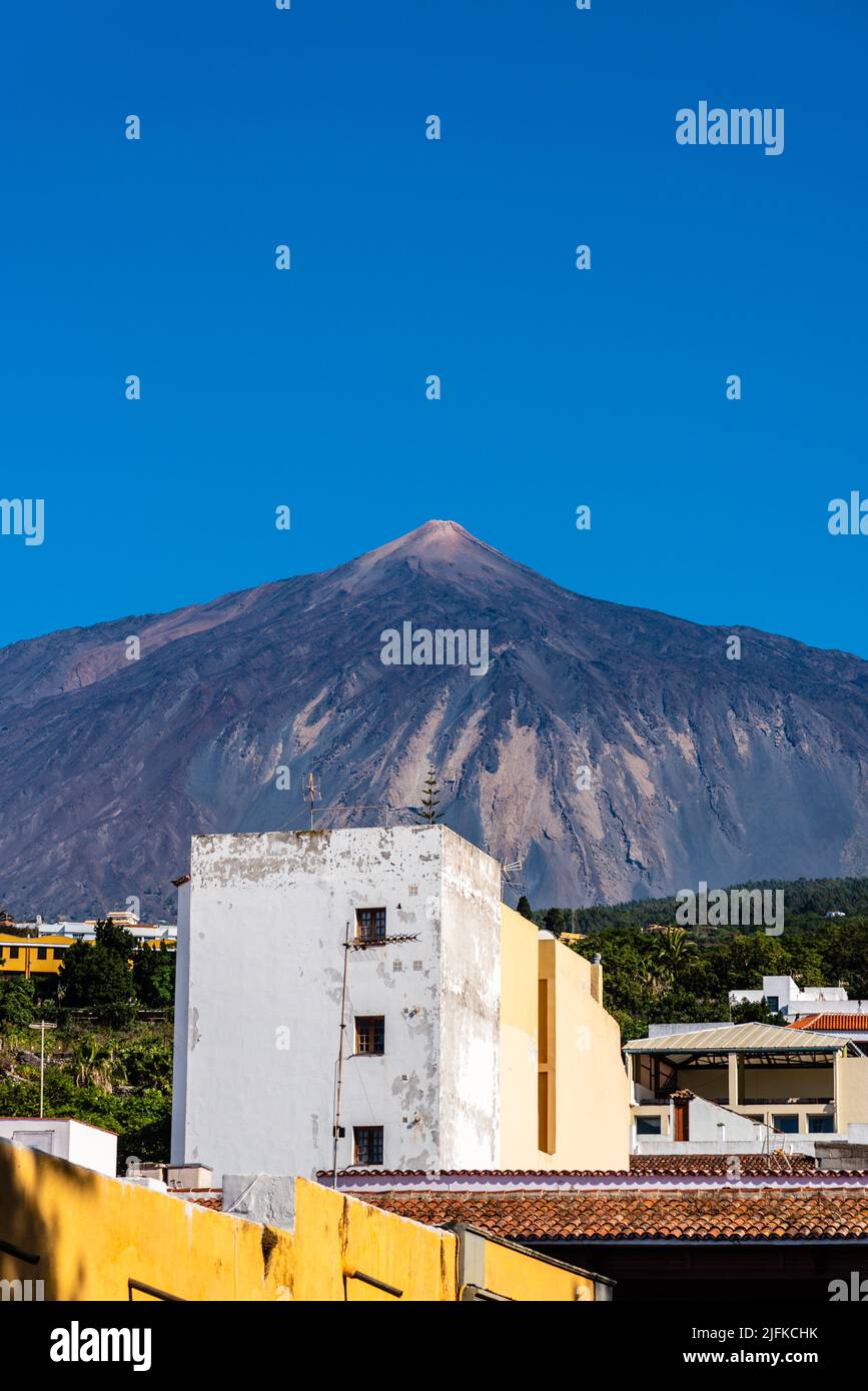 View of the Teide volcano from Icod de los Vinos on a sunny day with blue sky. Tenerife, Canary Islands, Spain. Stock Photo