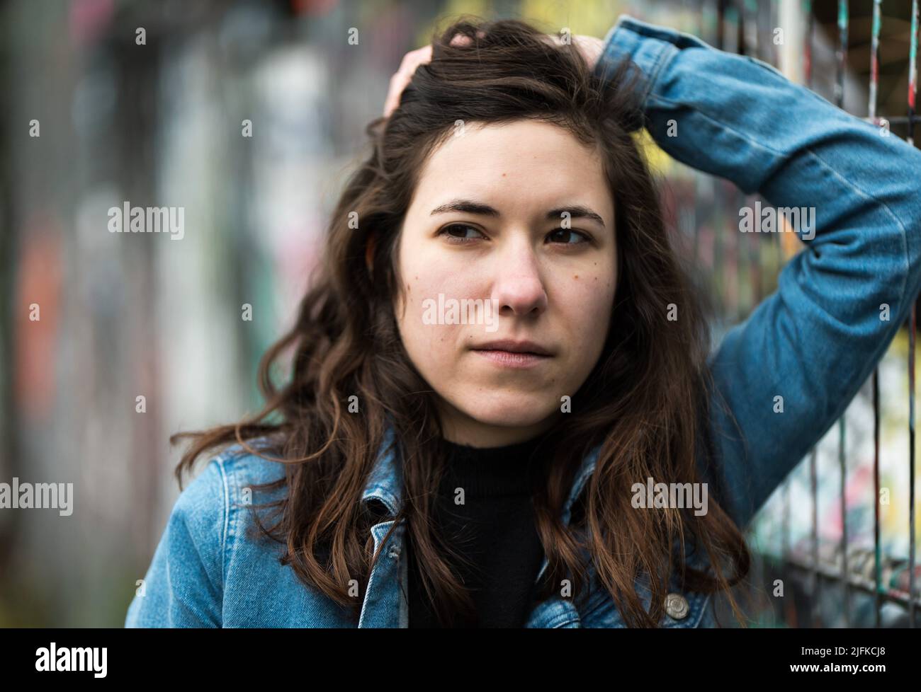 27 year old white woman posing against a metal grid, Brussels, Belgium