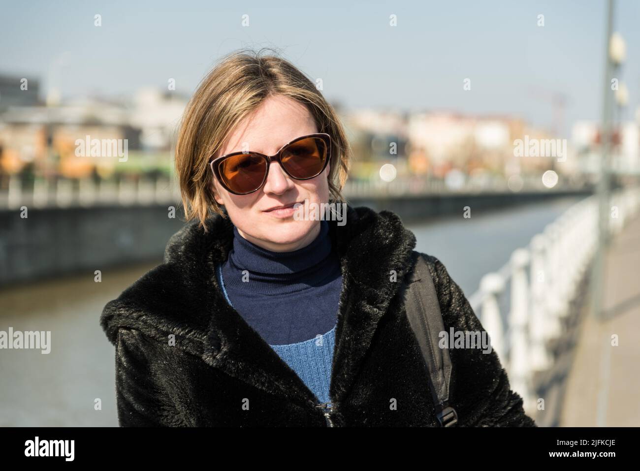 Attractive thirty year old woman posing at the Brussels canal, Anderlecht, Belgium. Stock Photo