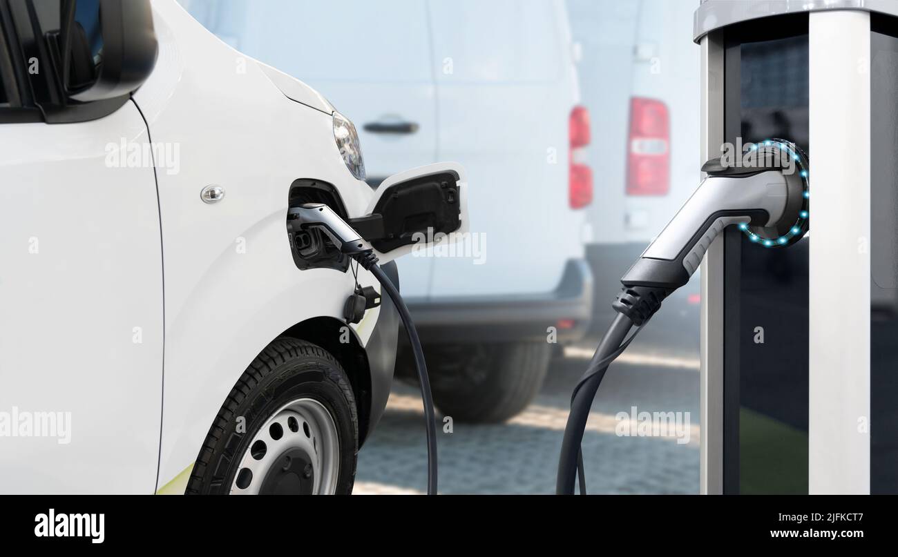 Electric vehicles charging station on a background of a van. Concept Stock Photo