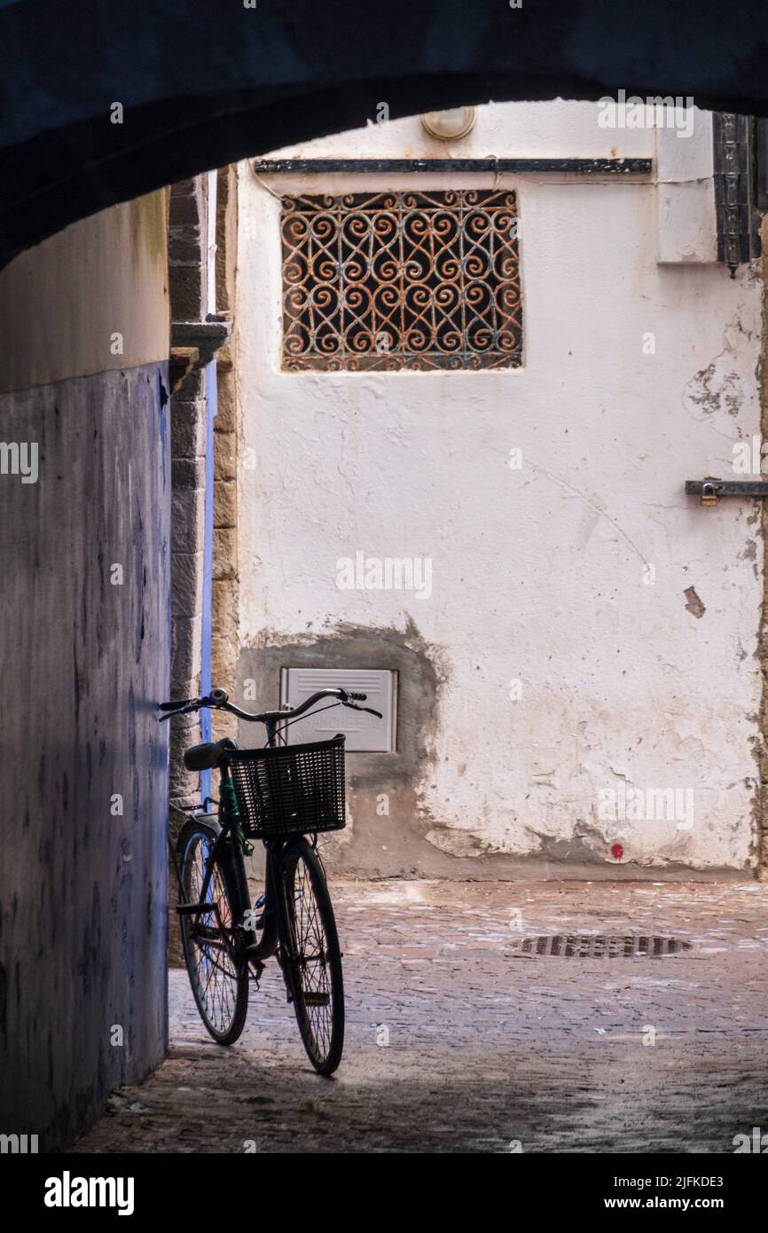bicycle silhouette under the arches of the medina , Essaouira, morocco, africa. Stock Photo