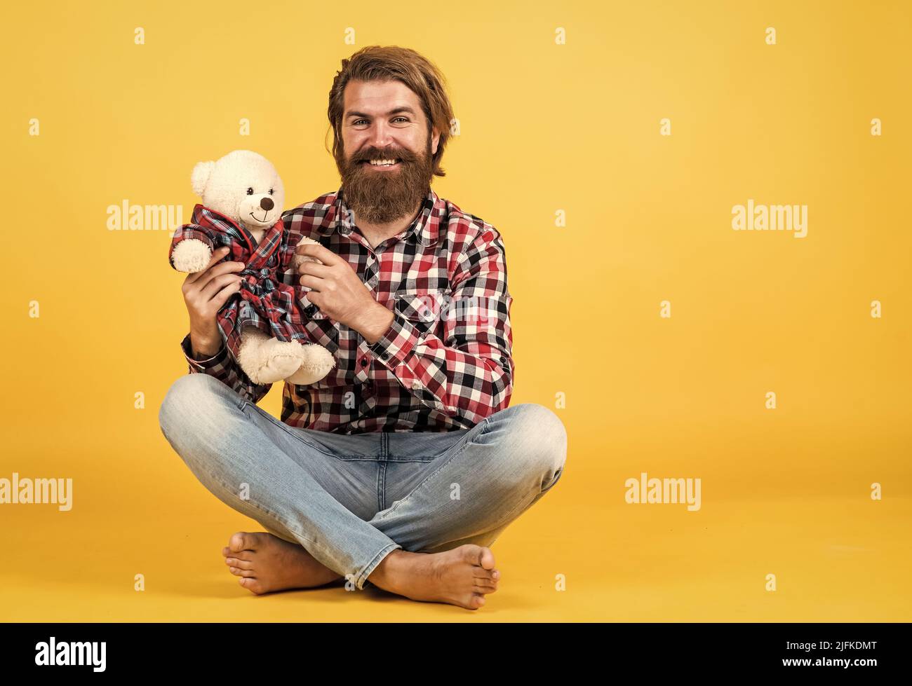 friendship concept. brutal mature hipster man play with toy. happy birthday. being in good mood. happy valentines day. cheerful bearded man hold teddy Stock Photo
