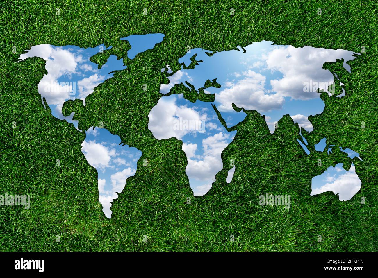 Mirror in the form of world map on green grass. Sky reflection. Concept 