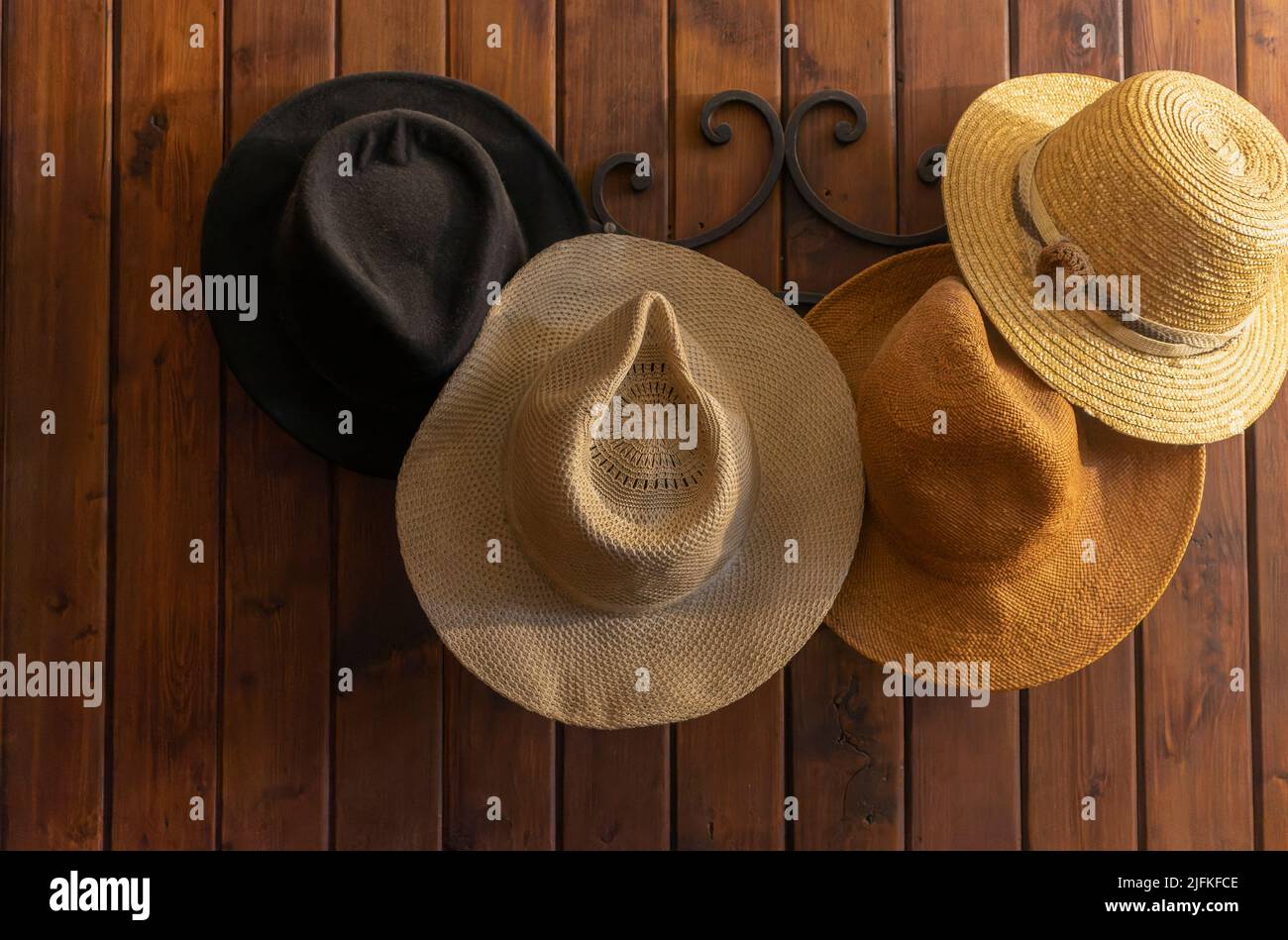photograph of antique hats hanging on wall rack Stock Photo