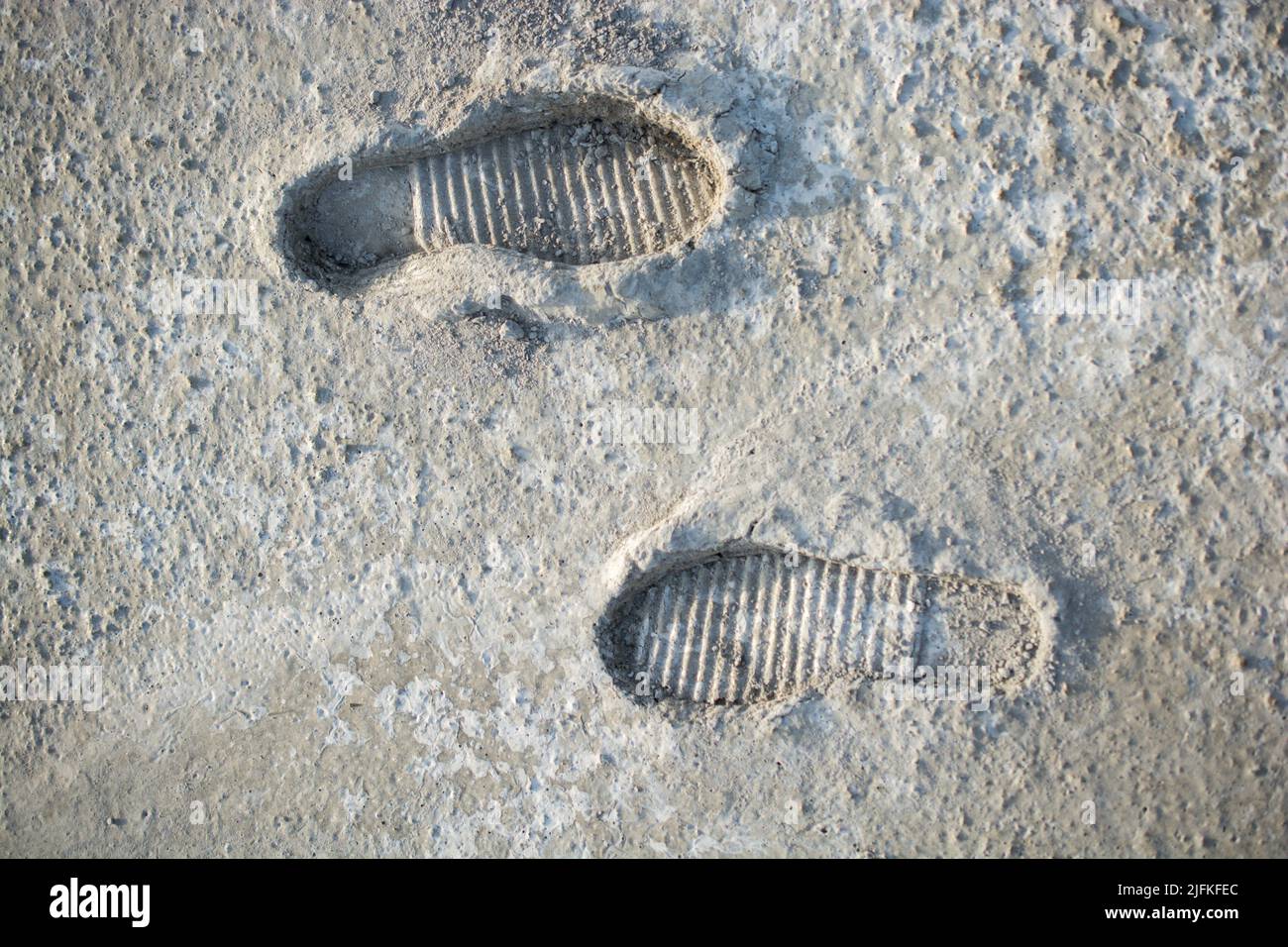 Footstep pattern seen on a concrete background. Stock Photo