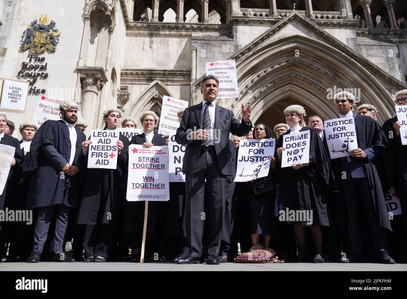 Jo Sidhu chair of the Criminal Bar Association, speaks to criminal defence barristers gathered outside the Royal Courts of Justice in London to support the ongoing Criminal Bar Association (CBA) action over Government set fees for legal aid advocacy work. Picture date: Monday July 4, 2022. Stock Photo
