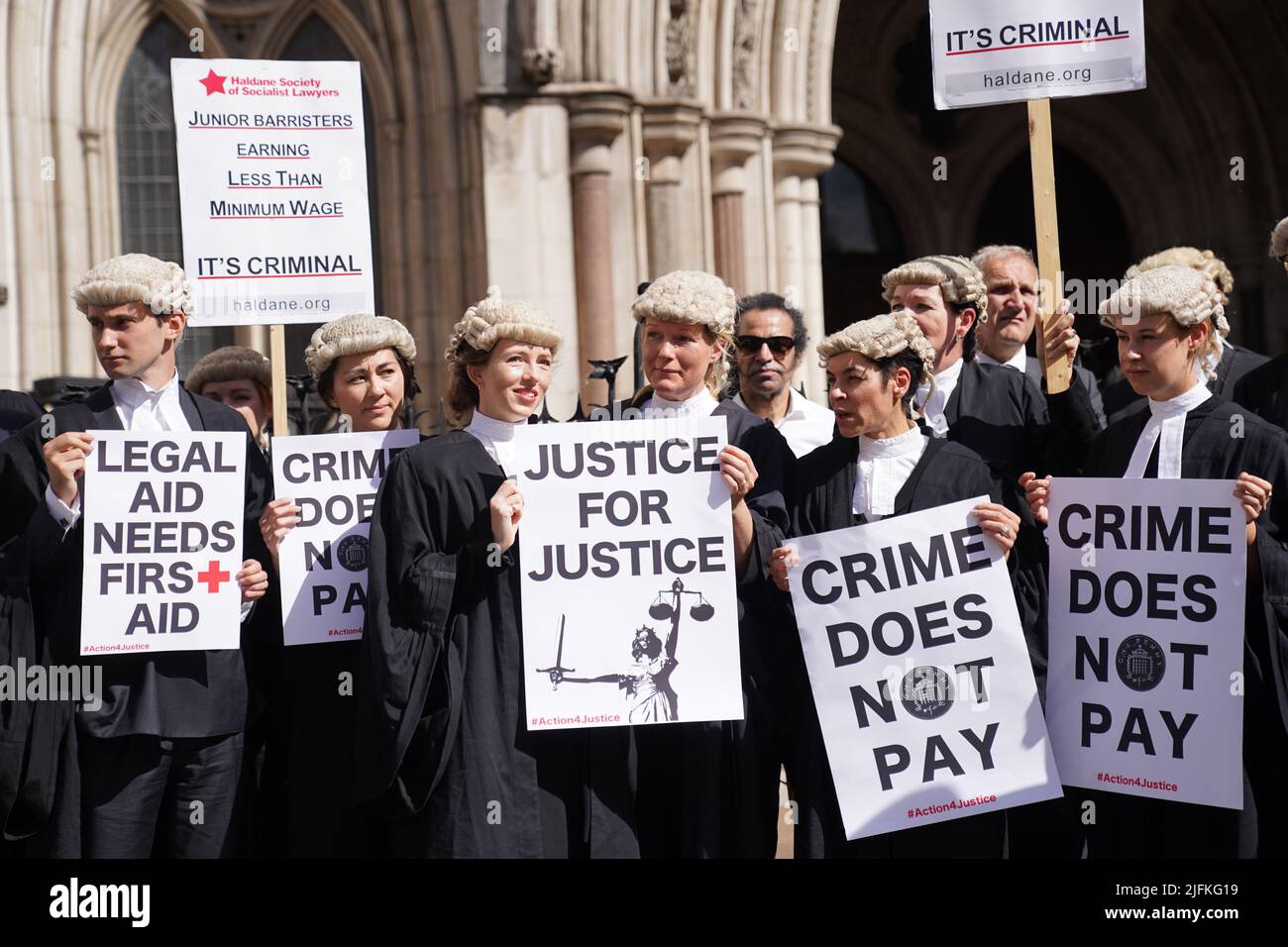 Criminal defence barristers gather outside the Royal Courts of Justice in London to support the ongoing Criminal Bar Association (CBA) action over Government set fees for legal aid advocacy work. Picture date: Monday July 4, 2022. Stock Photo