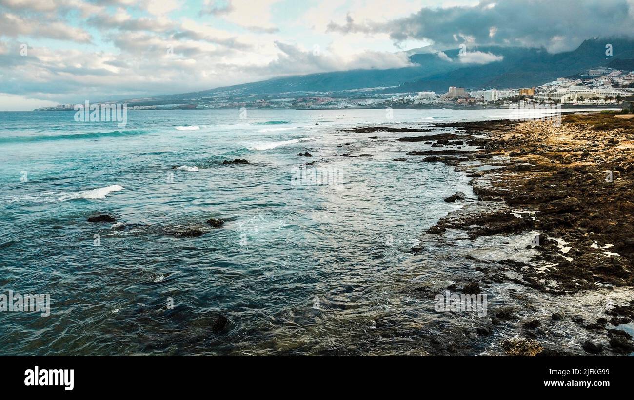 View of dramatic coast with rocks and blue ocean water. Sky with clouds at the horizon. Concept of touristic place for holiday vacation. Scenic Stock Photo