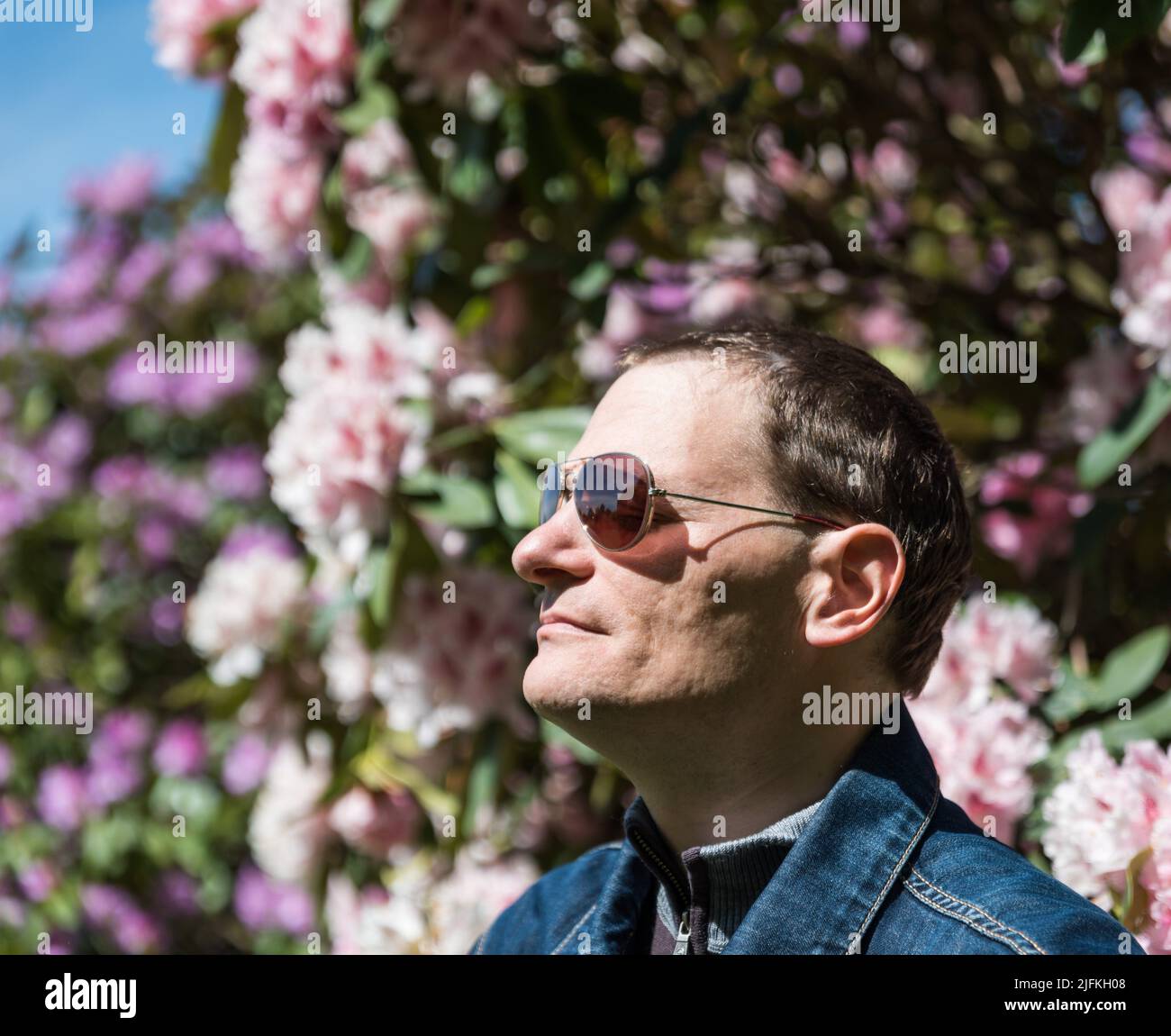 Portrait of a 40 year old man with sunglasses, natural background