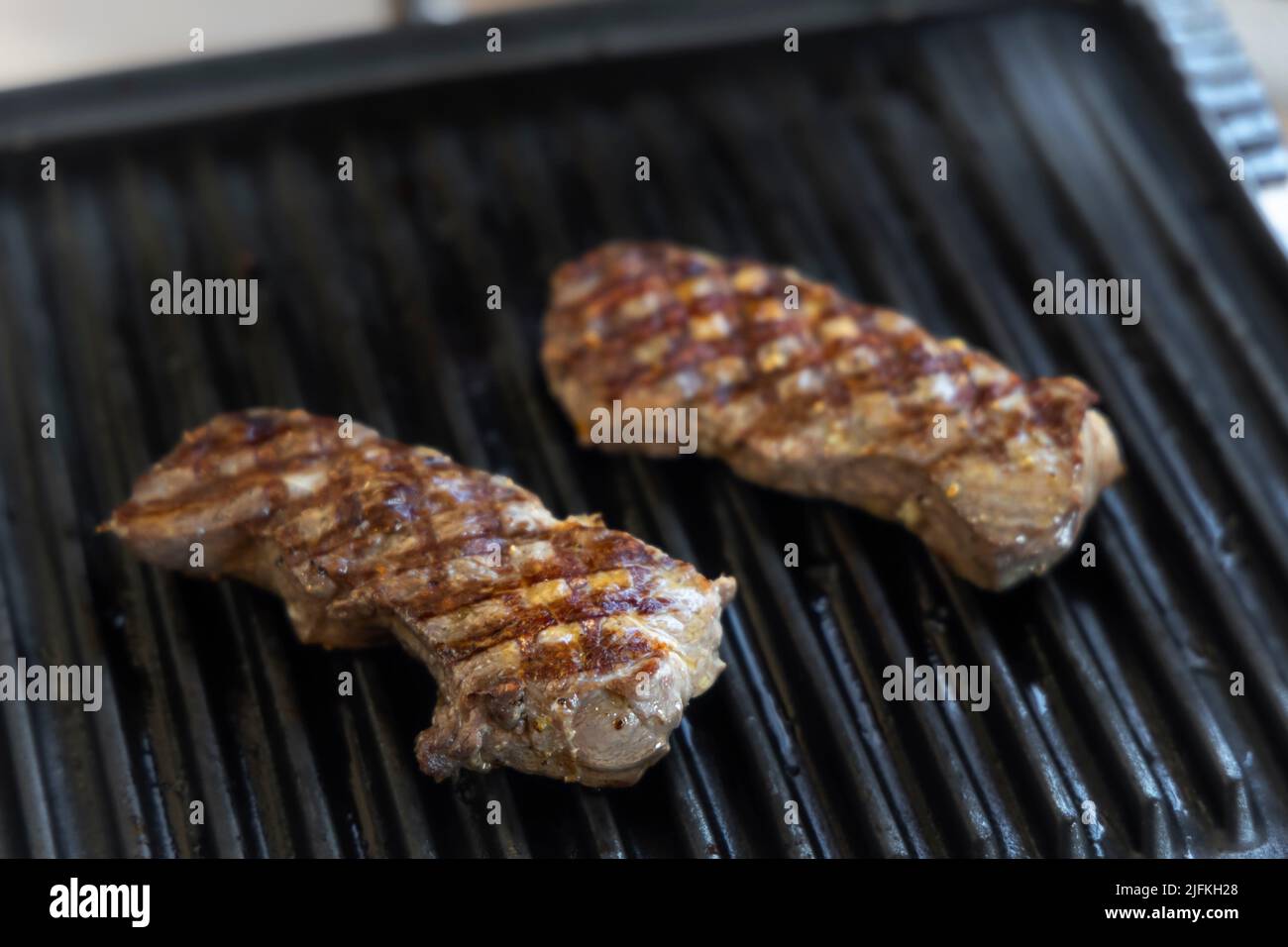 Electric grill with roast beef Stock Photo Alamy