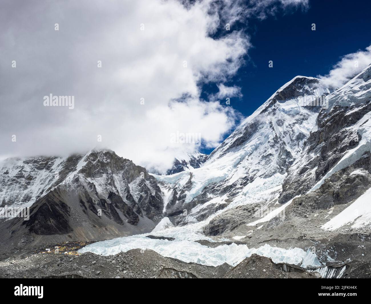 Everest Base Camp in the distance at the left edge of the Khumbu Icefall. Khumbutse (6636m) (l), and the West Shoulder are visible, Stock Photo