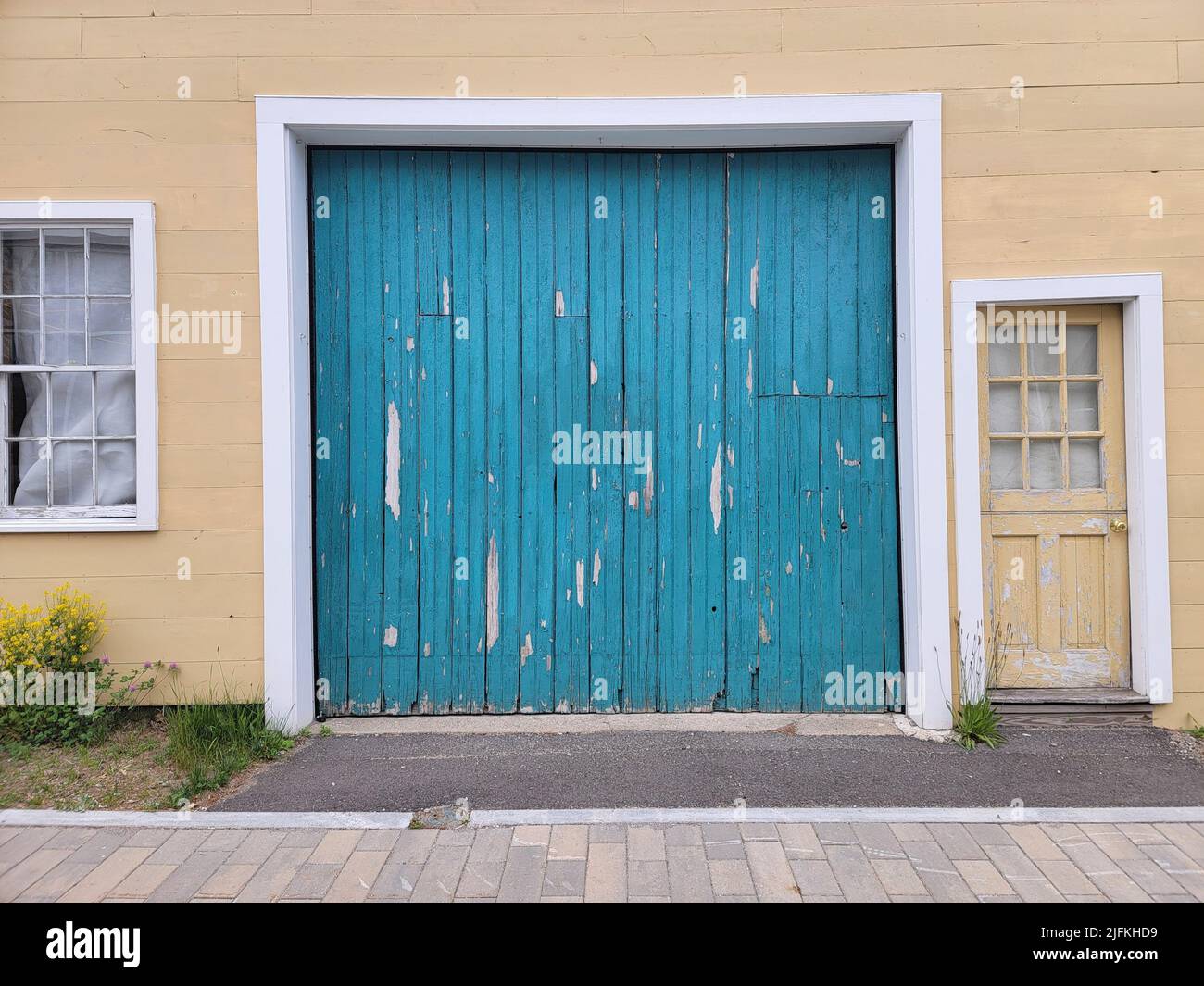 A weathered and paint peeling wooden garage door with dirty windows in the  Warehouse Arts District in downtown Tucson, AZ Stock Photo - Alamy