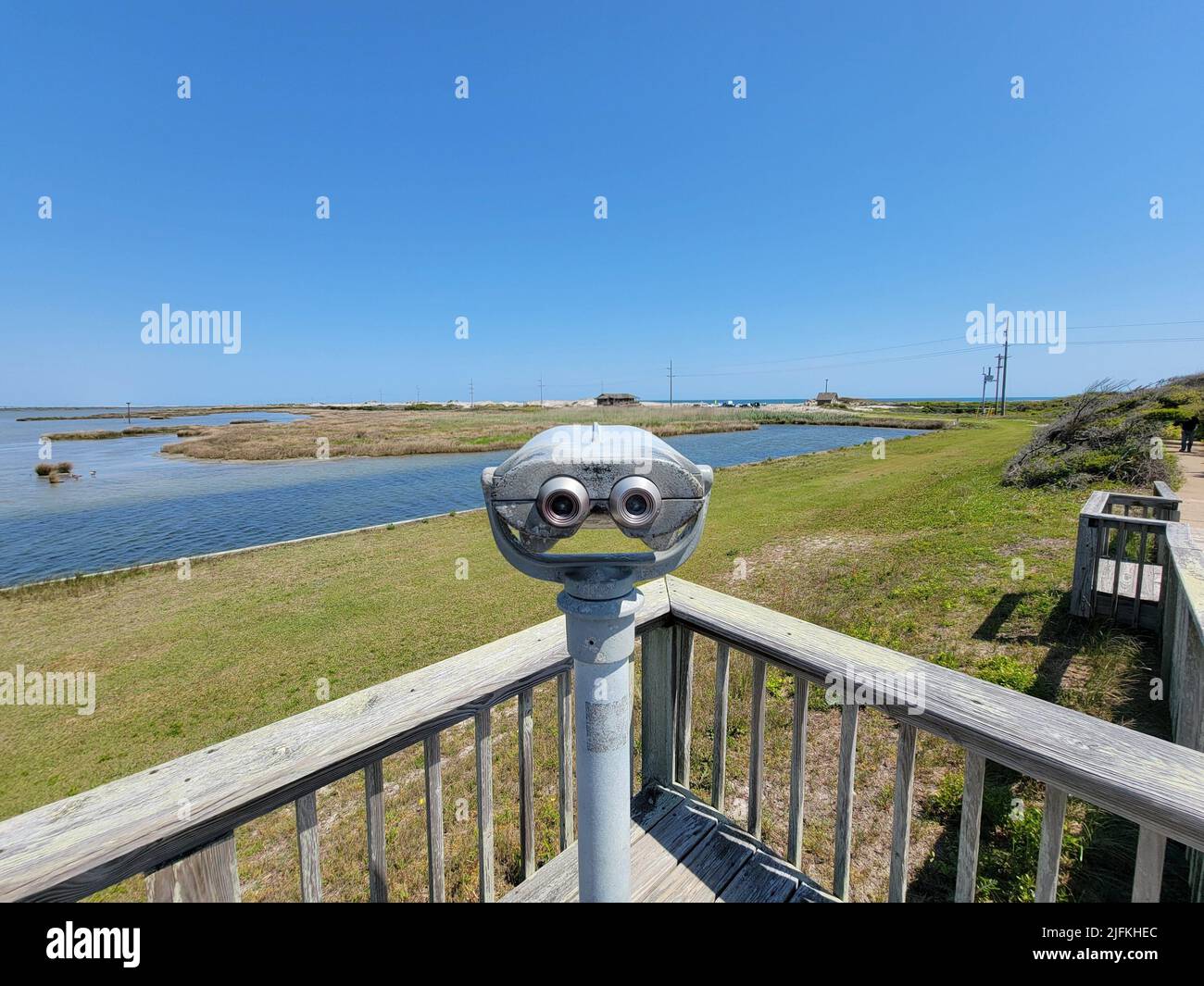 viewfinder or binoculars with water and green grass and blue sky outdoor. Stock Photo