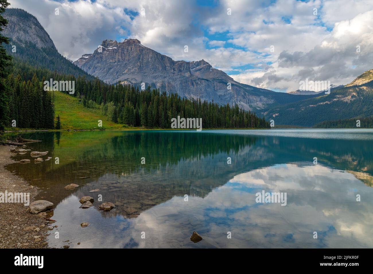 Reflecting mountains in the Emerald Lake in Yoho National Park, British Columbia, Canada. Stock Photo