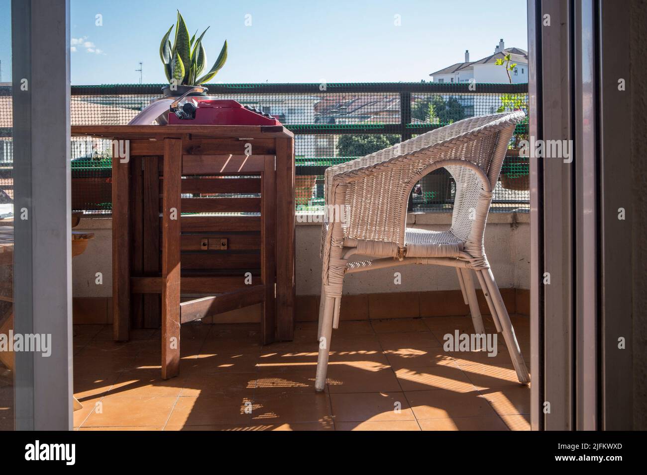 Urban home terrace with 1970s typewriter. Pleasant atmosphere for writing books. Stock Photo