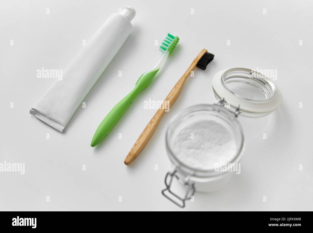 toothbrushes, toothpaste and soda in jar Stock Photo Alamy